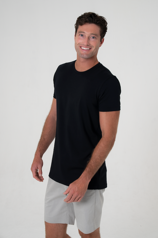 Tall man wearing Tall Daddy black premium long torso t-shirt with extended length and refined drape